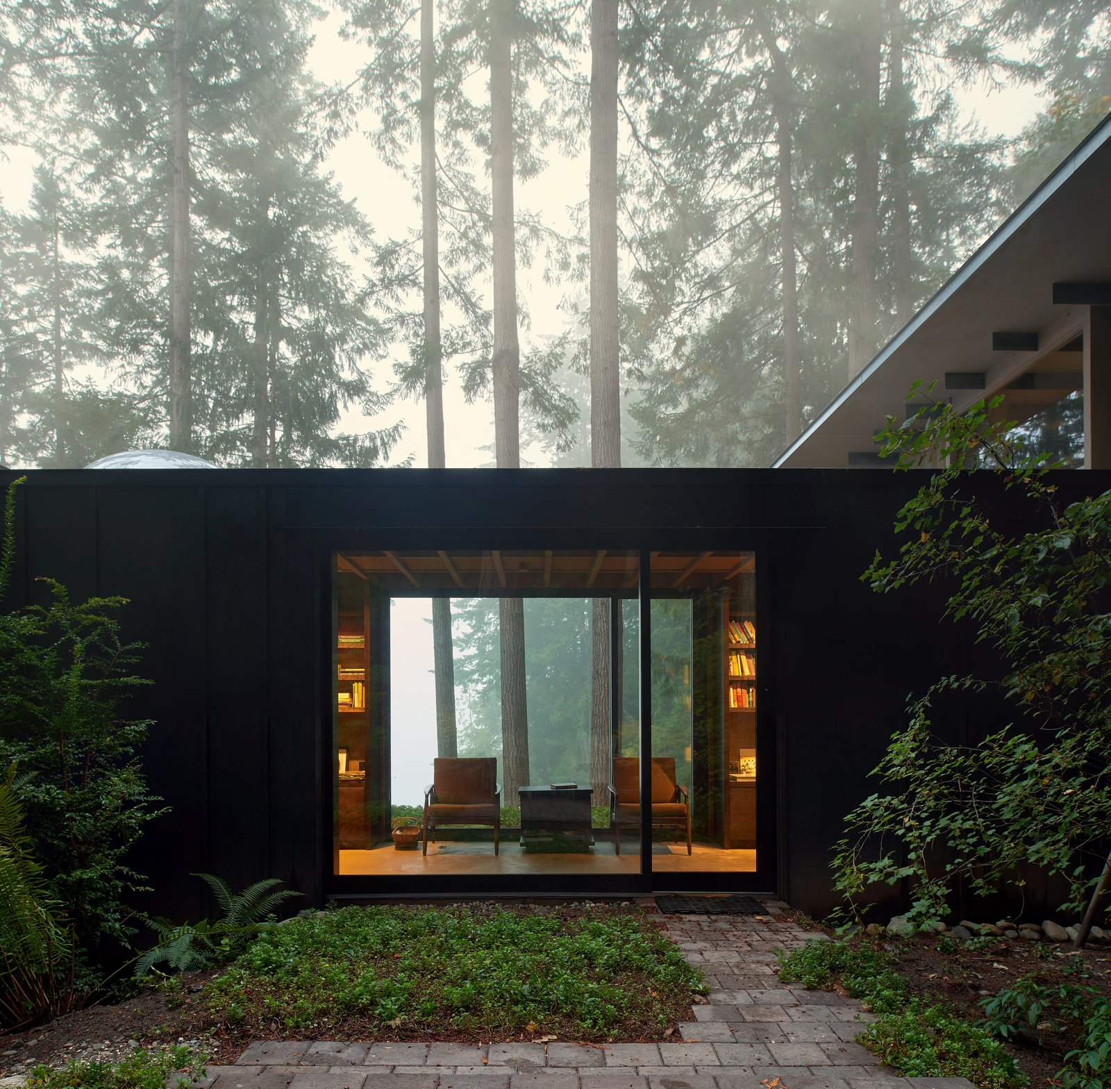 the-cabin-is-intentionally-subdued-in-color-and-texture-allowing-it-to-recede-into-the-woods-and-defer-to-the-beauty-of-the-landscape.jpg